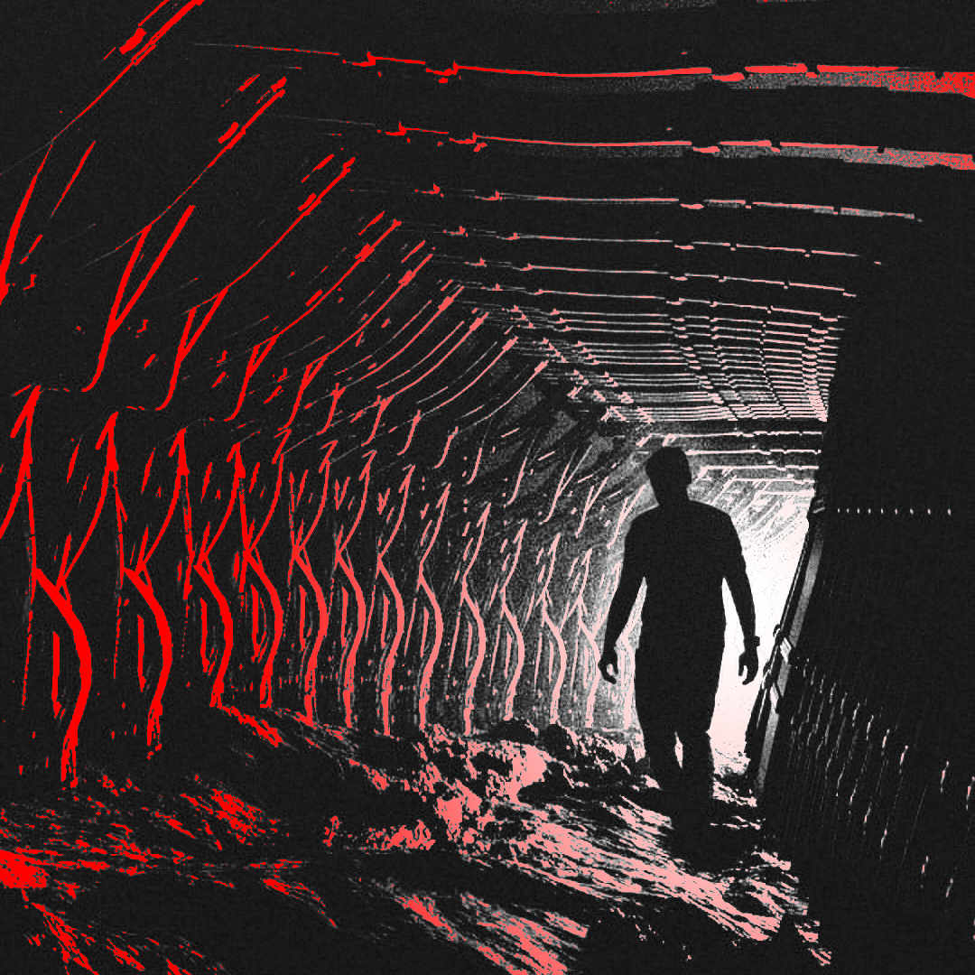 Man walking through tunnel